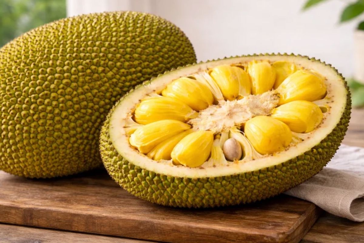 a fruit cut in half on a cutting board